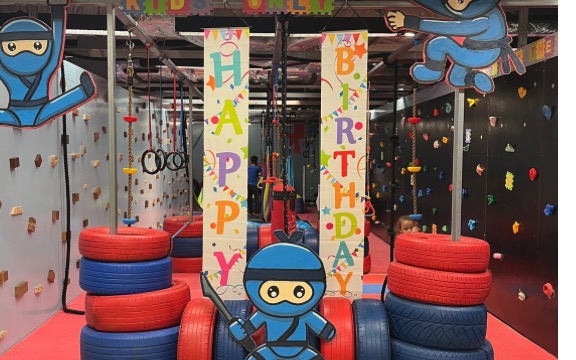 Birthday banners and the blue ninja mascot at NinjaGym