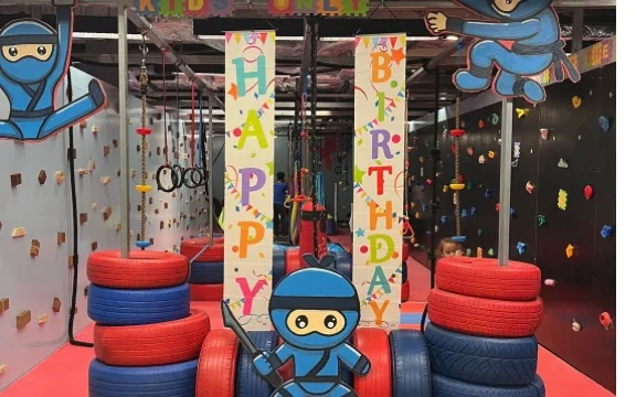 Birthday banners and the blue ninja mascot at NinjaGym