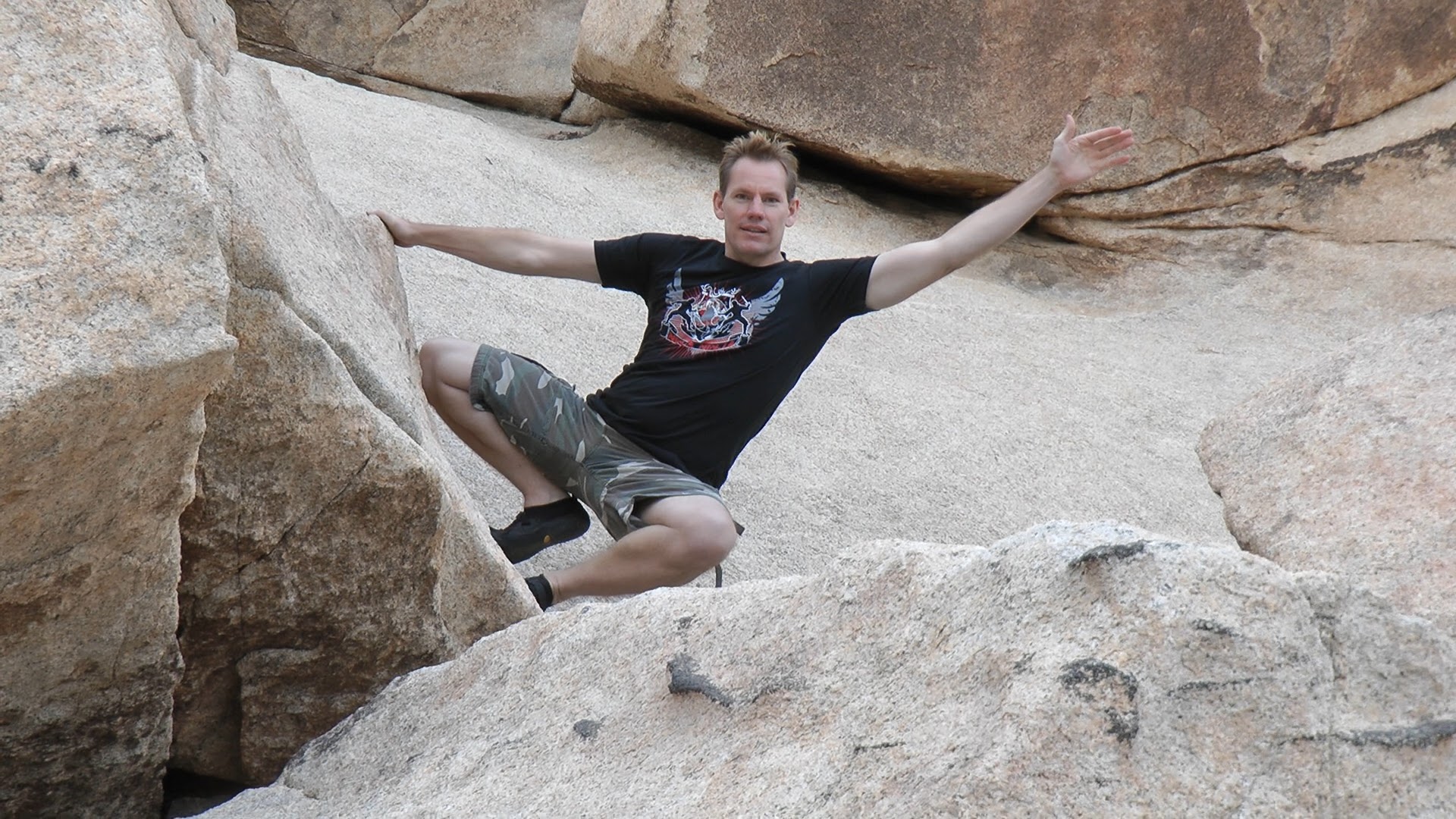 Rick Tew stretching between rocks